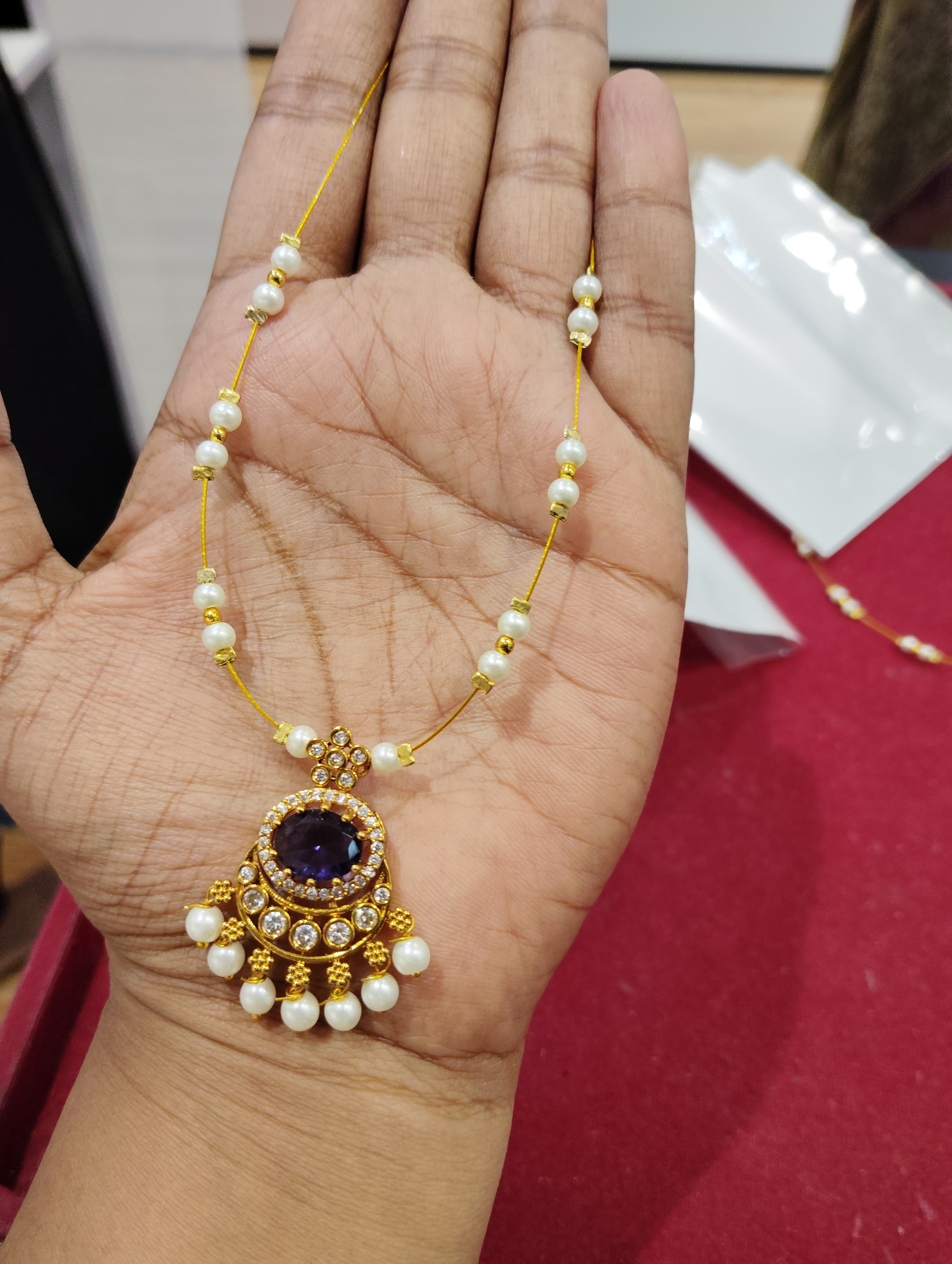 Necklace with purple round pendant, clear accents and white bead-threaded fine chain