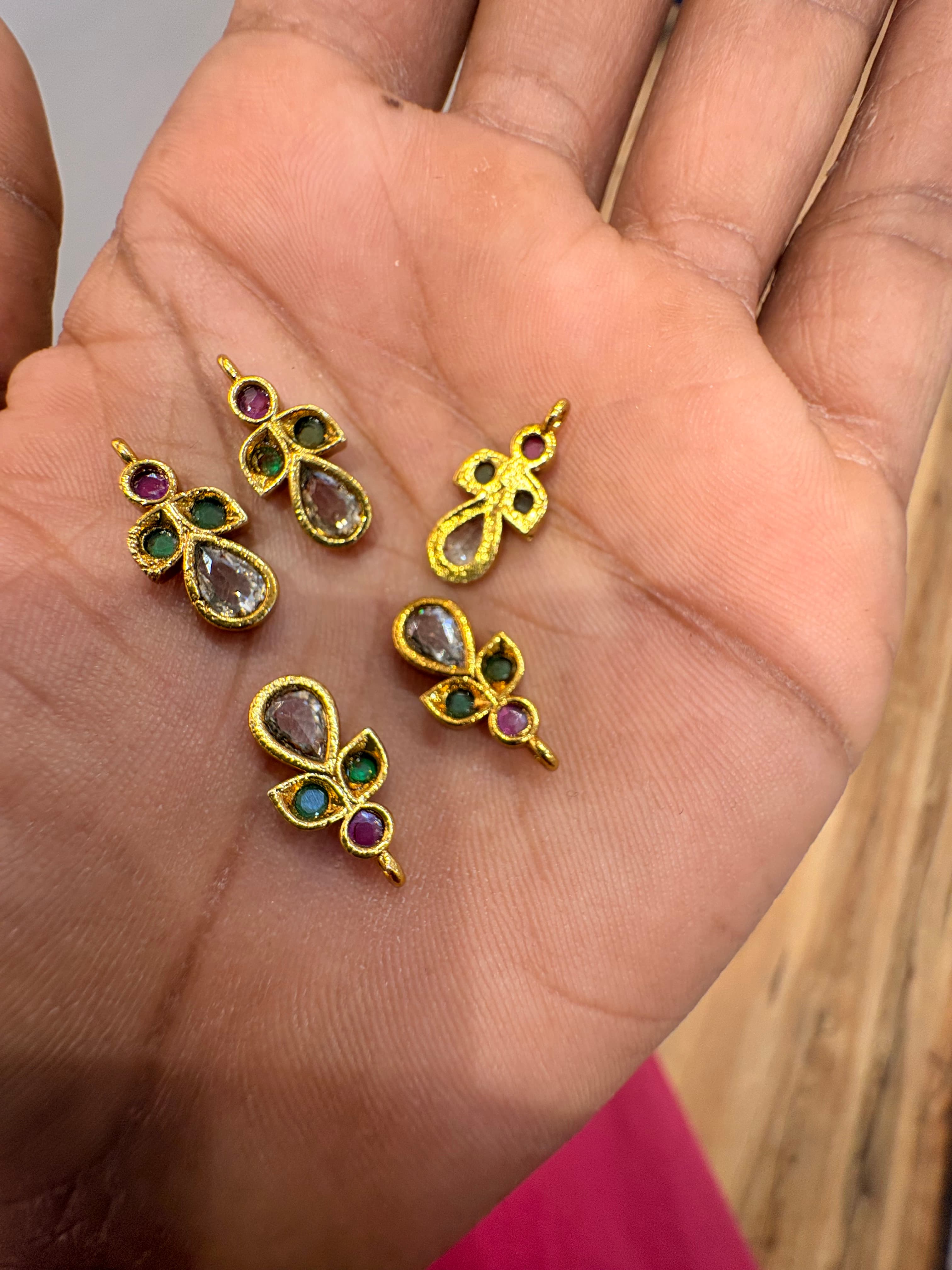 Small gold-tone teardrop bits with round pink and green accents and top attachment loop