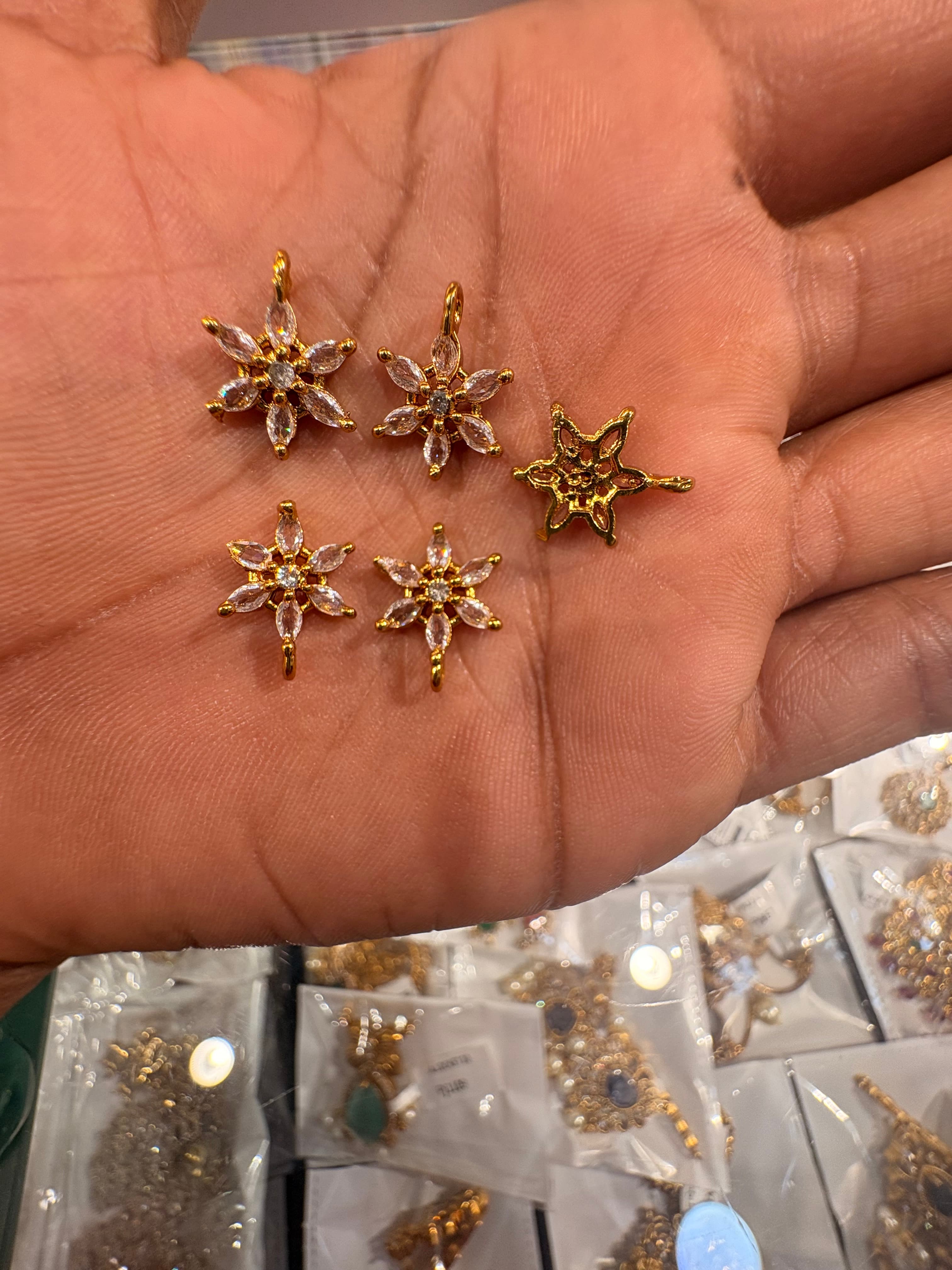 Gold-colour star-flower jewellery bits with clear marquise-shaped decorative accents