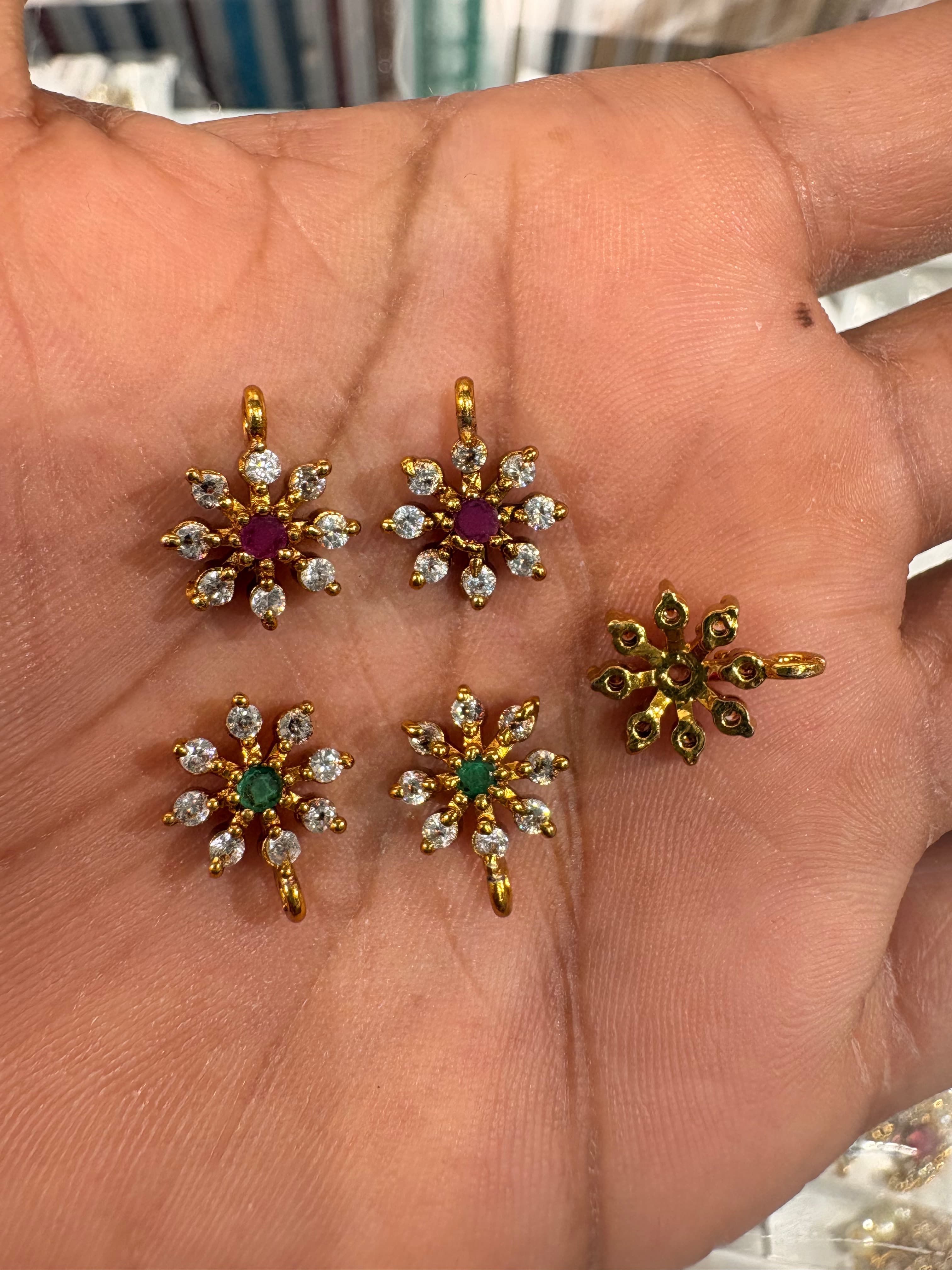 Small gold-colour floral starburst pendant bits with clear round accents and coloured centres