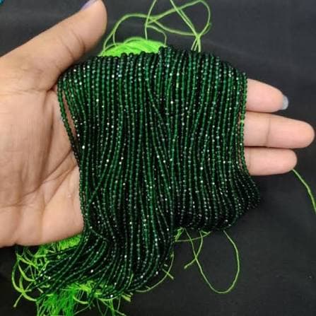Single strand of small dark green faceted hydro beads on green thread