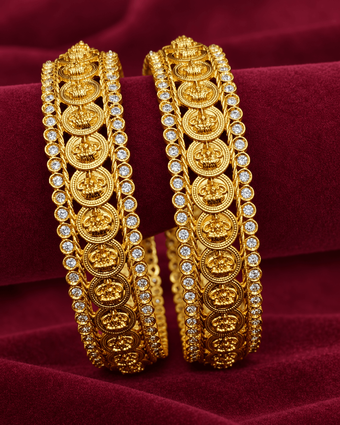 Gold-toned bangles with coin motifs and clear stone rows